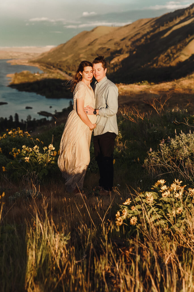 Couple stands on cliffside 