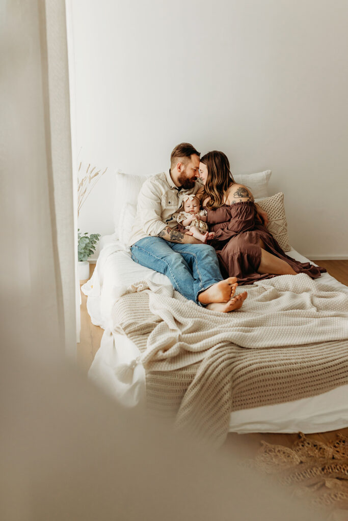 Portland Oregon Family Photographer. Family snuggling on bed