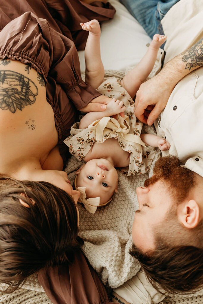 Family snuggles on bed. Vancouver, Washington family photographer