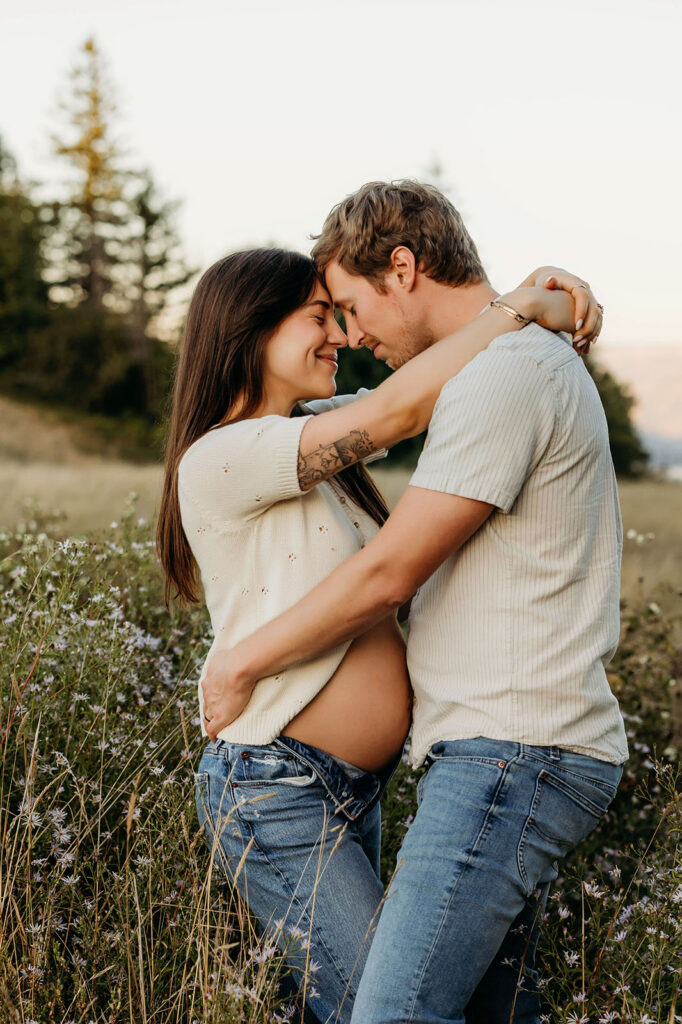 couple hugging during maternity session outdoors Vancouver Washington
