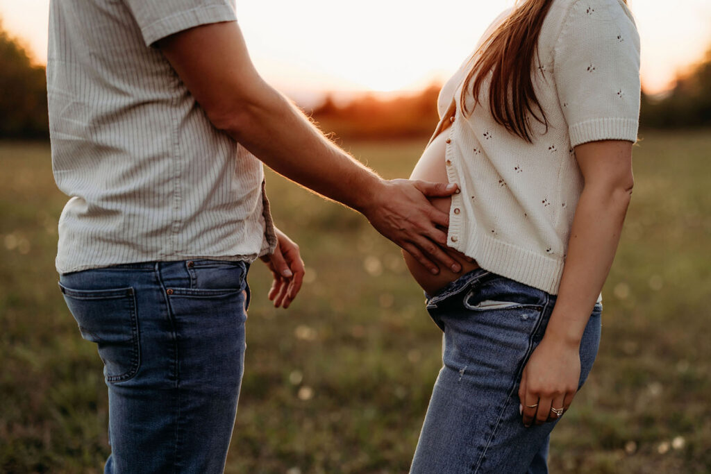 close up of mom's belly with dad's hand detailed sweater cardigan Vancouver Washington