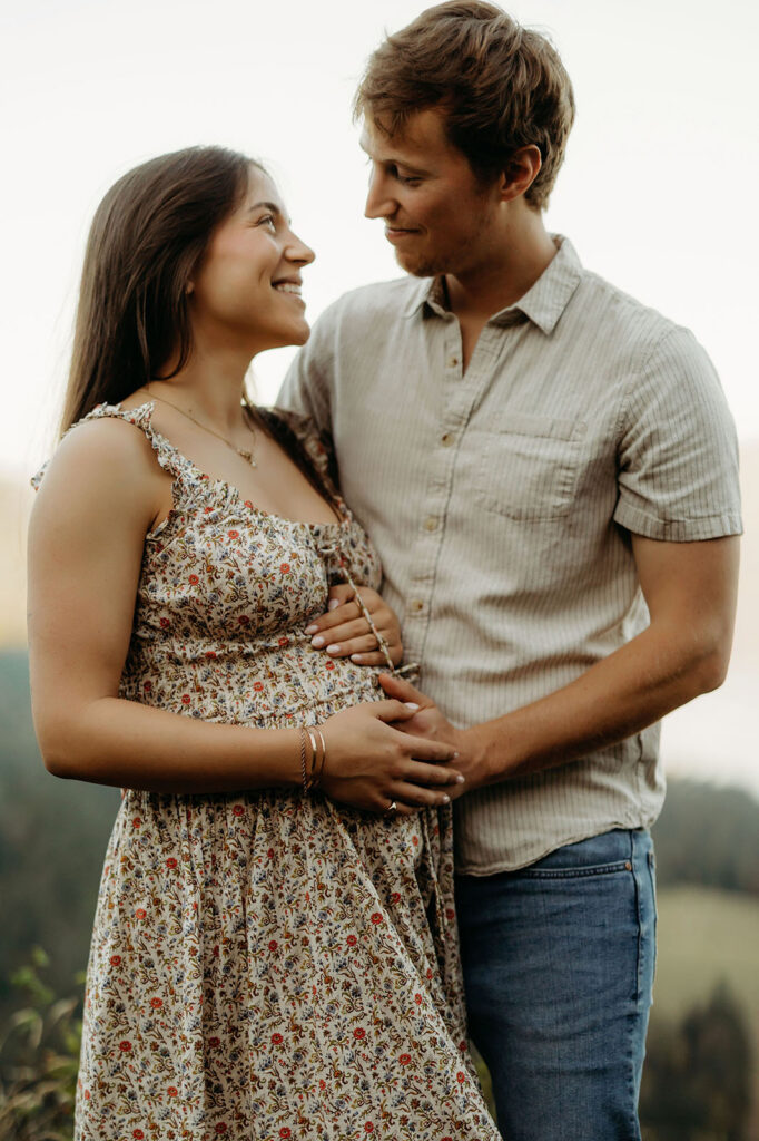 Mom wearing casual maternity dress twirling in Columbia River Gorge Vancouver WA